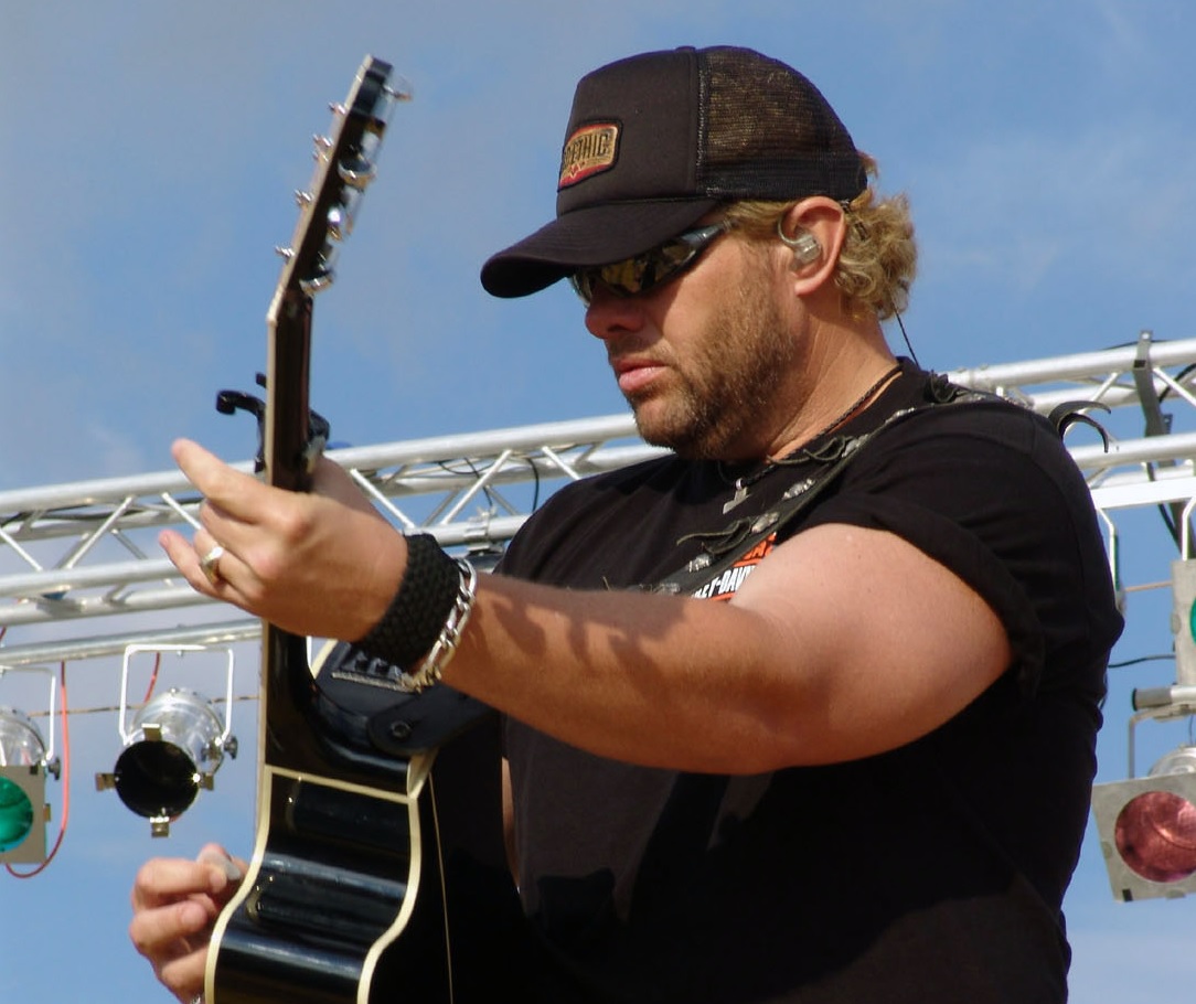 Toby Keith playing guitar in a Live performance